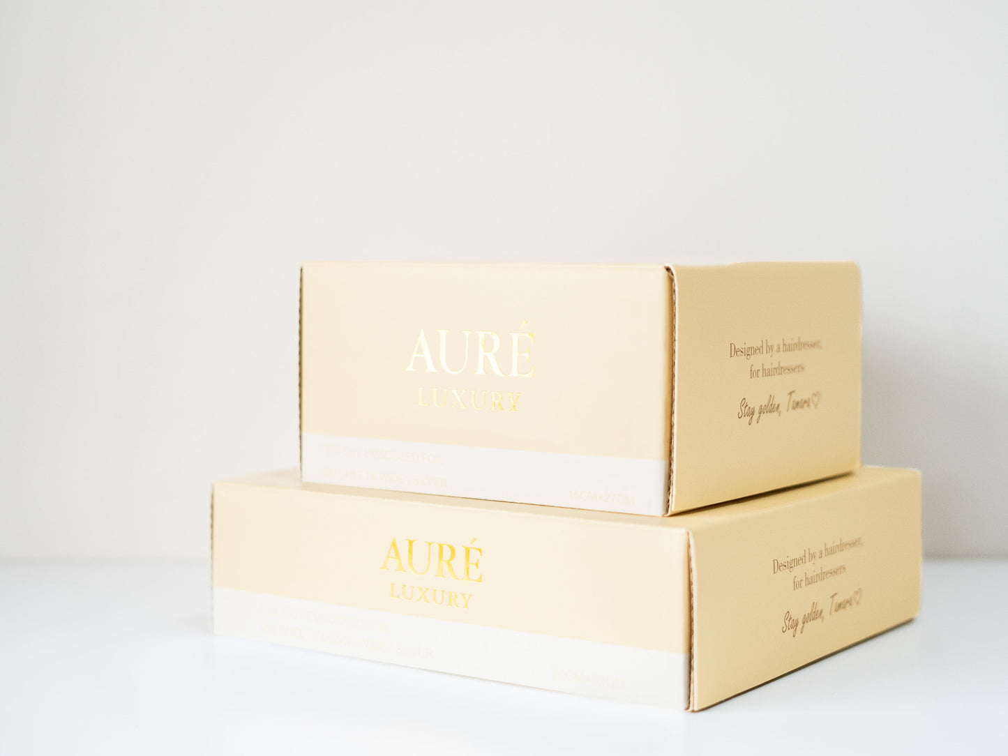 Two beige boxes with 'AURE' branding on a white background