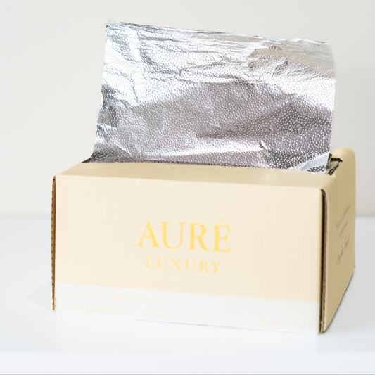 Silver-wrapped product in a beige box with 'AURE' branding on a white background