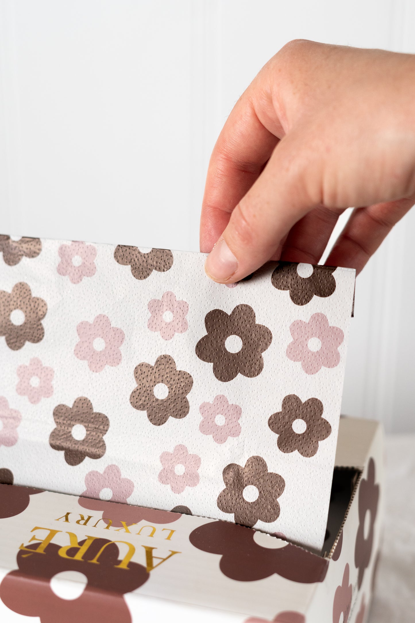 Hand holding a box of Aure Luxury pre-cut embossed hair foils design for salons in australia