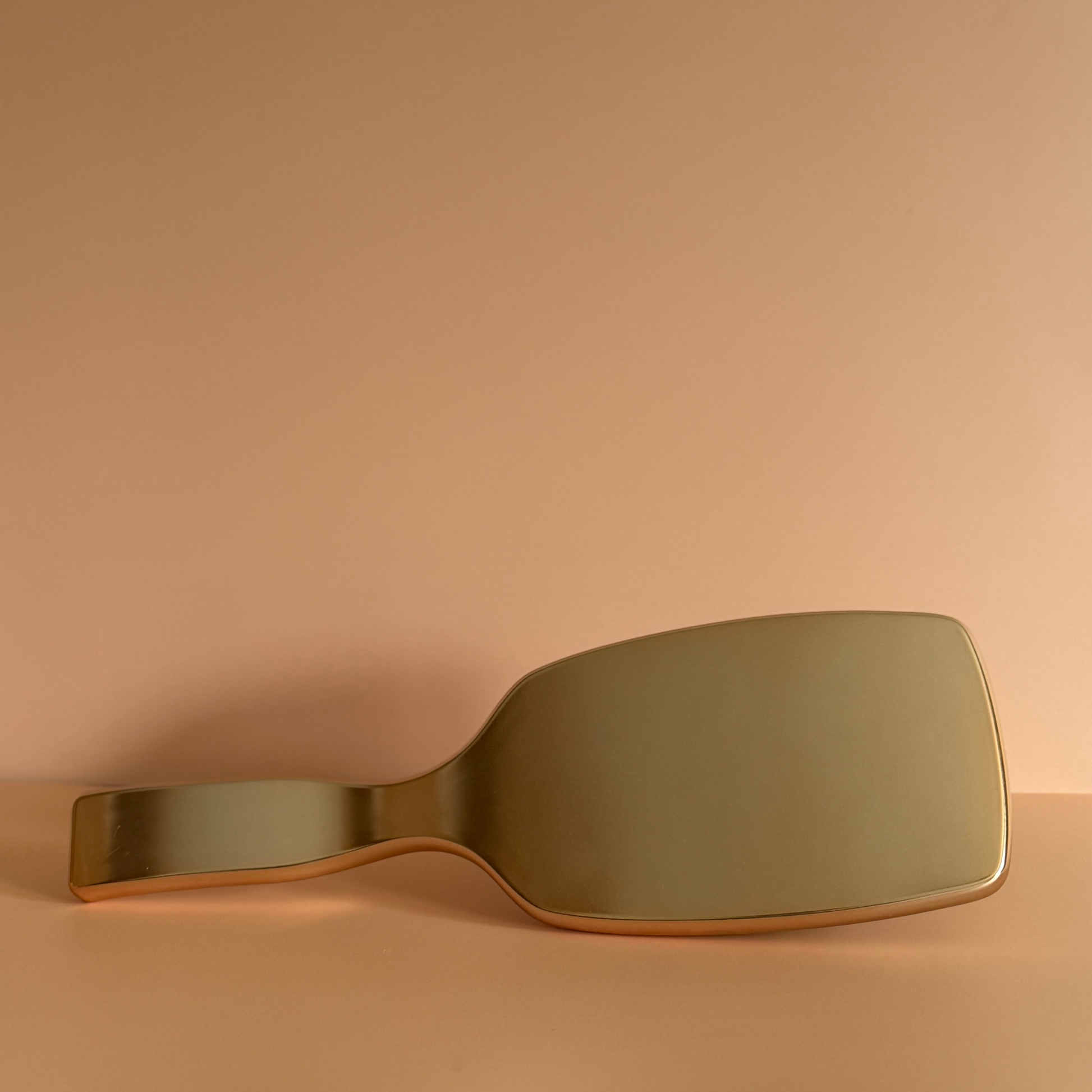 Gold-colored brush on a beige background