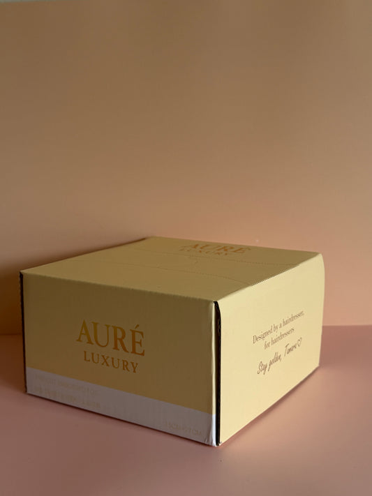 Gold box with 'Aure Luxury' branding on a matching background